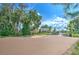 Outdoor community basketball court surrounded by mature trees and landscaping for residents to enjoy at 10210 White Linen Ave, Riverview, FL 33578
