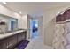 Elegant bathroom with a double sink vanity, granite countertops, and a stylish shower curtain at 10210 White Linen Ave, Riverview, FL 33578