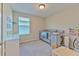 Bedroom with a crib, changing table, play area, and window at 10210 White Linen Ave, Riverview, FL 33578