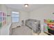 Bedroom with a gray crib, changing table, and play area, perfect for a young  at 10210 White Linen Ave, Riverview, FL 33578