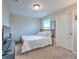 Carpeted bedroom with a full bed, TV, and natural light at 10210 White Linen Ave, Riverview, FL 33578
