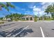 Community clubhouse exterior showcasing manicured landscaping, ample parking, and architectural details at 10210 White Linen Ave, Riverview, FL 33578