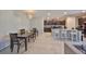 Bright dining area open to the kitchen, featuring a dark wood table and barstool seating at 10210 White Linen Ave, Riverview, FL 33578