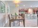 Bright dining room showcases modern lighting, decorative wall art, and kitchen view at 10210 White Linen Ave, Riverview, FL 33578