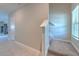 Bright hallway with staircase leading to the upper level, window, and neutral wall color at 10210 White Linen Ave, Riverview, FL 33578