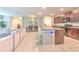 Open-concept kitchen with granite counters, stainless appliances, island, and seamless flow to the dining and living areas at 10210 White Linen Ave, Riverview, FL 33578