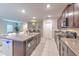 Modern kitchen with granite countertops, stainless steel appliances, and island with breakfast bar at 10210 White Linen Ave, Riverview, FL 33578