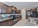 Well-equipped kitchen featuring dark cabinets, granite countertops, and modern appliances at 10210 White Linen Ave, Riverview, FL 33578