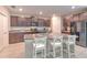 Modern kitchen with dark cabinets, granite countertops, and island seating at 10210 White Linen Ave, Riverview, FL 33578