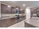 Dark cabinets and granite countertops highlight this modern, eat-in kitchen at 10210 White Linen Ave, Riverview, FL 33578