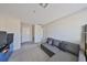 Spacious living room featuring plush gray sofa, neutral walls, and ample natural light at 10210 White Linen Ave, Riverview, FL 33578