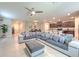 Spacious living room with contemporary sectional sofa open to dining and kitchen area at 10210 White Linen Ave, Riverview, FL 33578