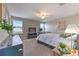Bright bedroom with a ceiling fan, two windows, and a decorative plant on a bedside table at 10210 White Linen Ave, Riverview, FL 33578