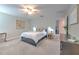 Comfortable main bedroom features neutral colors, ceiling fan, and natural light at 10210 White Linen Ave, Riverview, FL 33578