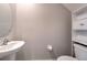 Half bath shows pedestal sink and cabinet storage at 10210 White Linen Ave, Riverview, FL 33578