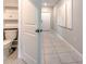 Hallway view including toilet room with tiled floors and white fixtures at 10210 White Linen Ave, Riverview, FL 33578
