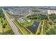Aerial view showcasing the community pool, clubhouse, ponds, and numerous homes at 10732 Chippewa Dr, Parrish, FL 34219