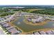 The house from an aerial perspective, positioned on a pond and in a residential community at 10732 Chippewa Dr, Parrish, FL 34219