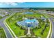 Beautiful aerial view of the community amenities, featuring a pool, playground, and lush landscaping at 10732 Chippewa Dr, Parrish, FL 34219