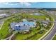 Expansive aerial shot of the community, showcasing the clubhouse, pool, playground, and neighborhood at 10732 Chippewa Dr, Parrish, FL 34219