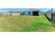 Well-maintained, grassy backyard featuring black metal and white fencing for added privacy at 10732 Chippewa Dr, Parrish, FL 34219