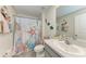 Coastal-themed bathroom with a vanity, decorative accents, and a shower with a marine-inspired curtain at 10732 Chippewa Dr, Parrish, FL 34219