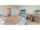 Bedroom features comfortable bed, dresser, natural light from the window, and functional furniture at 10732 Chippewa Dr, Parrish, FL 34219