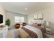 Relaxing bedroom featuring a plush bed, neutral decor, and lots of natural light from the window at 10732 Chippewa Dr, Parrish, FL 34219