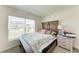 Inviting bedroom with a large window, comfortable bed, and a classic bedside table with lamp at 10732 Chippewa Dr, Parrish, FL 34219
