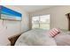 Cozy bedroom featuring a bed with patterned bedding, a flat-screen TV, and a bright window at 10732 Chippewa Dr, Parrish, FL 34219