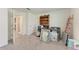 Bedroom with neutral walls, light carpet, and an open doorway to a hallway creating an open and bright atmosphere at 10732 Chippewa Dr, Parrish, FL 34219