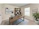 A bright home office featuring a desk, shelving, and a comfortable workspace at 10732 Chippewa Dr, Parrish, FL 34219