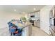 Open kitchen featuring granite countertops, stainless appliances, and a breakfast bar with seating at 10732 Chippewa Dr, Parrish, FL 34219