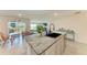 Kitchen featuring granite counters, stainless steel appliances, and seamless access to the living area at 10732 Chippewa Dr, Parrish, FL 34219