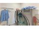 Modern laundry room featuring a stacked washer and dryer set, with a sleek gray finish, and ample storage space at 10732 Chippewa Dr, Parrish, FL 34219