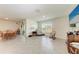 Bright living room featuring tile flooring, large windows, and a comfortable seating area at 10732 Chippewa Dr, Parrish, FL 34219