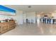 Open-concept living room with modern tile flooring and seamless flow into the kitchen at 10732 Chippewa Dr, Parrish, FL 34219