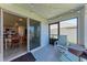 Cozy screened patio with sliding glass door access to the home's interior dining area at 10732 Chippewa Dr, Parrish, FL 34219