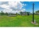 Community playground with swings, slides, and play structures surrounded by green grass at 10732 Chippewa Dr, Parrish, FL 34219