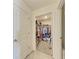 View of a walk-in closet filled with clothing and accessories; door visible at 10732 Chippewa Dr, Parrish, FL 34219