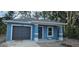 Charming single-story home with an attached garage, covered porch, and blue exterior at 1107 Howard St, Clearwater, FL 33756