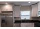 A well-equipped kitchen featuring stainless steel appliances, shaker cabinets, and black granite countertops at 1107 Howard St, Clearwater, FL 33756