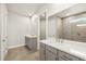 Bathroom features double vanity, large mirror, and glass-enclosed shower with tiled walls at 11737 Myakka Blue Dr, Venice, FL 34293