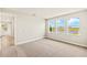Bedroom with neutral carpet and three windows with a water view at 11737 Myakka Blue Dr, Venice, FL 34293