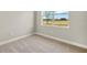 Bedroom with neutral carpet and one window for natural light at 11737 Myakka Blue Dr, Venice, FL 34293