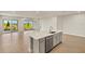 Modern kitchen with a large center island, stainless steel appliances, and stylish gray cabinets at 11737 Myakka Blue Dr, Venice, FL 34293