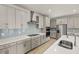 Modern kitchen with a large center island, stainless steel appliances, and stylish gray cabinets at 11737 Myakka Blue Dr, Venice, FL 34293