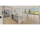 Modern kitchen with a large center island, stainless steel appliances, and stylish gray cabinets at 11737 Myakka Blue Dr, Venice, FL 34293