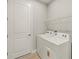 Well-lit laundry area features a Whirlpool washer/dryer and wire shelving for efficient organization at 11737 Myakka Blue Dr, Venice, FL 34293