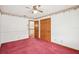Bedroom featuring carpet, ceiling fan, and closet with views to hallway at 12099 Luxembourg Ct, Spring Hill, FL 34609